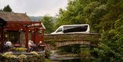 A Mountain Goat Tours Minibus Crossing a Bridge in the Lake District, Cumbria