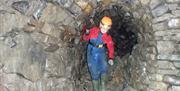 Visitor Exploring a Mine with Go Cave in the Lake District and Cumbria