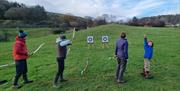 Visitors on an Archery Experience with Path to Adventure in the Lake District, Cumbria