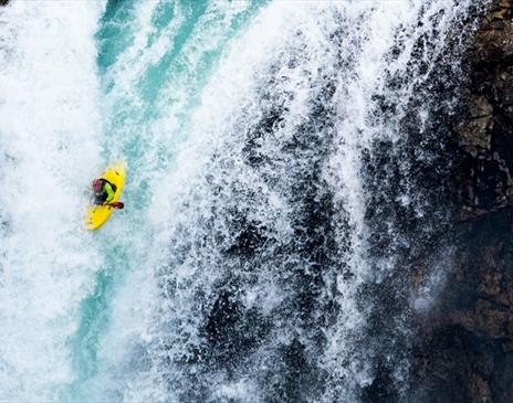Person Kayaking over a Waterfall, Promoting the Paddling Film Festival at Brewery Arts in Kendal, Cumbria