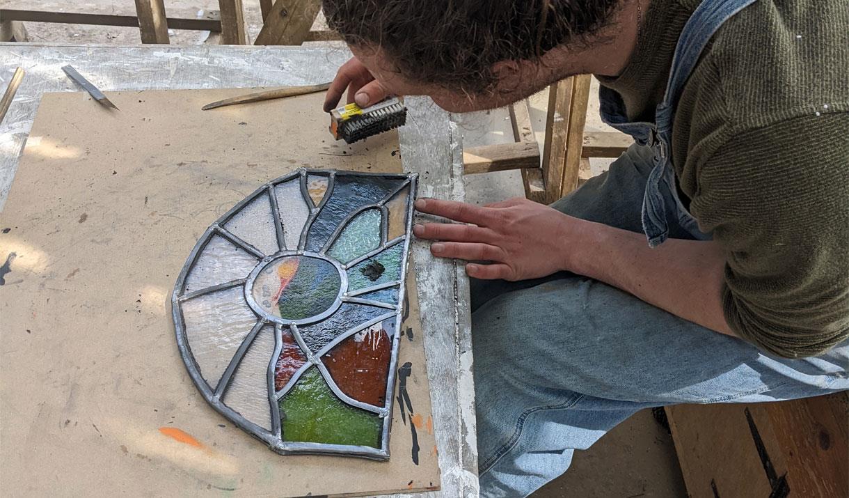Visitor Working on Stained Glass at a Workshop at Quaker Tapestry Museum in Kendal, Cumbria