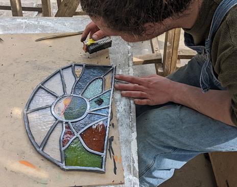Visitor Working on Stained Glass at a Workshop at Quaker Tapestry Museum in Kendal, Cumbria