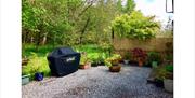Patio and BBQ area at The Saplings in Bothel, Cumbria