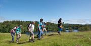 Walkers at Tarn Hows in the Lake District, Cumbria