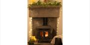 Wood Burner with Festive Decorations at The Carthouse at The Green Cumbria in Ravenstonedale, Cumbria