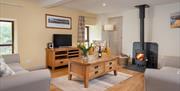 Living Room and Wood Burning Stove at The Old Byre at Fornside Farm Cottages in St Johns-in-the-Vale, Lake District