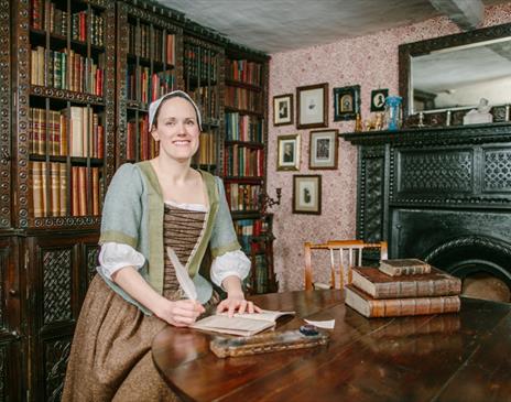 Staff Member in Period Clothing Smiling at Townend in Troutbeck, Lake District