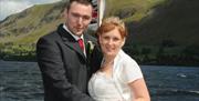 Wedding couple with Lakeland fells in the background.
