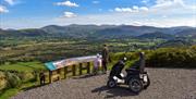 Family Looking Out at an Accessible Viewpoint at Whinlatter Forest in the Lake District, Cumbria