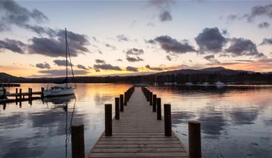 View from a Jetty over Windermere with a Dramatic Sunset in the Lake District, Cumbria