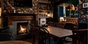 Dining Room Tables and Fireplace at The Angel Inn in Bowness-on-Windermere, Lake District