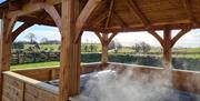 Keep warm in a hot tub at Low Ploughlands Holiday Lets in Little Musgrave, Cumbria