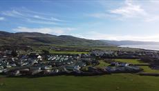 Aerial photo of Sarnfaen Holiday Park and Snowdonia mountains in the distance