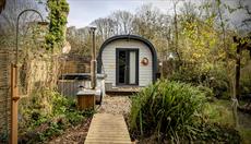Glamping pod with raised walkway and outdoor shower