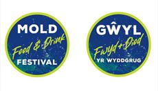 Circular logos for the Mold Food & Drink Festival, colours are blue and green. One English and one Welsh version.