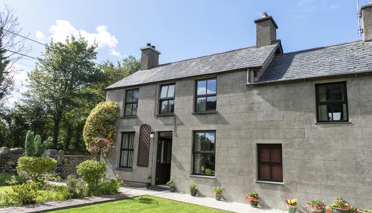 The cottage from the front. The parking is at the back of the cottage accessed via a level concrete pathway