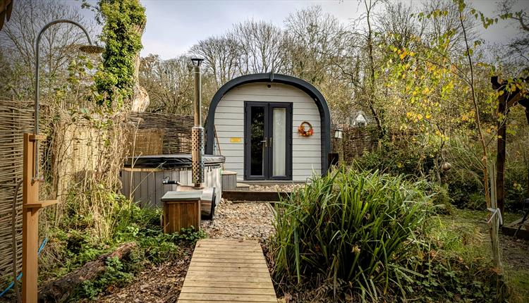 Glamping pod with raised walkway and outdoor shower