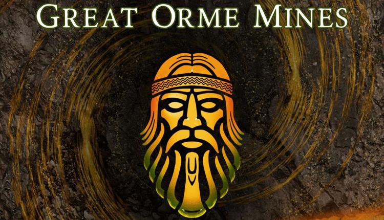 Two people standing in the underground tunnel.  The pair are facing in opposite directions from each other looking at the walls of the underground.