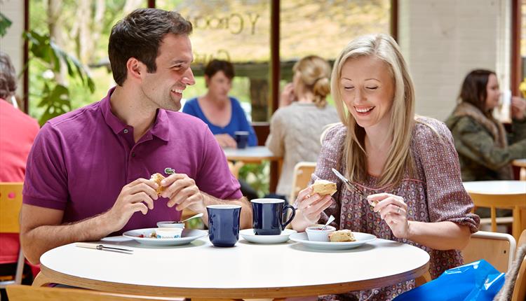 A couple eating scones and drinking tea at Corris Cafe