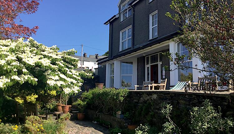 Wenallt Guest House front entrance from the garden on a sunny day.