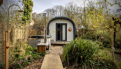 Glamping pod with raised walkway and outdoor shower