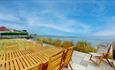 patio with table and chairs overlooking the sea at 105 Beach House