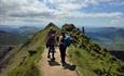 walkers descending a narrow path on snowdon