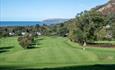 Golf green, and fairway with the sea in the distance