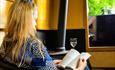 Woman reading a booking aboard a narrowboat