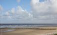 An image of Barkby Beach, long sandy beach with the tide out, only 5 minutes walk from the chalets