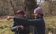 Man in woodland explaining landscape photography composition.