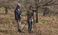 Brad Carr with landscape photography workshop client in a woodland.