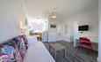 An image of the living area and kitchenette in a self catering chalet. With sofa bed to allow for adittional guests in this chalet.