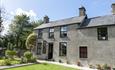 The cottage from the front. The parking is at the back of the cottage accessed via a level concrete pathway