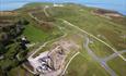 An aerial view of a green headland, where immediately below is the copper mine.