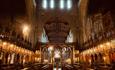 The lofty heights of the tower area at Bangor Cathedral with choir seats in the centre and carved wooden clergy stalls for priests behind