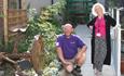 Museum Director, Dawn Lancaster, and CAIS Garden Group's organiser Gareth Evans standing in their pride and joy, the Biodiversity garden.