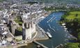 An aerial shot of the magnificent Caernarfon Castle, with Cei Llechi and the Welsh Highland railway in the distance.