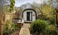 Glamping pod with raised walkway and outdoor shower
