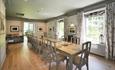 A large dining room table that will accommodate 24 people in the dining room at Plas Bodegroes