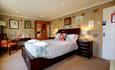 This image shows King bed with bedside cabinets, wardrobe and desk