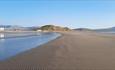 Wendon Holidays seen from the beach, with a glorious backdrop of mountains and the Hill forte.