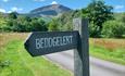 Beddgelert sign with mountain backdrop