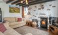 Gors-lwyd Cottage lounge with woodburner, smart TV and window view to Yr Eifl