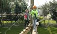 Image of 2 children on the high ropes