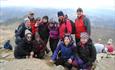 Walkers on top of Snowdon during a guided day walk with Large Outdoors