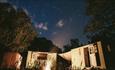 Snowdonia Shepherds' Huts at night under a starry sky with the firepit burning in the foreground