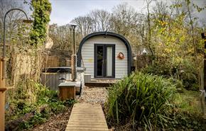 Glamping pod with raised walkway and outdoor shower