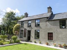 The cottage from the front. The parking is at the back of the cottage accessed via a level concrete pathway