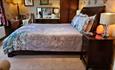 This image shows King bed with bedside cabinets, wardrobe and desk